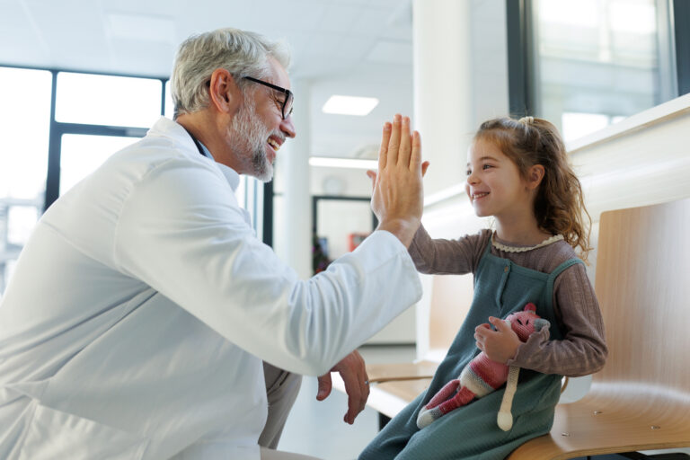 Doctor and child giving high-five